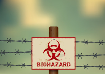 Biohazard symbol on a barbed wire fence.