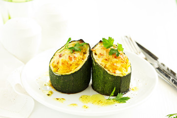 Baked zucchini stuffed with rice and vegetables.