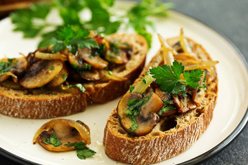 Bruschetta with fried mushrooms with onions and parsley.