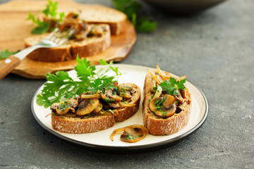Bruschetta with fried mushrooms with onions and parsley.