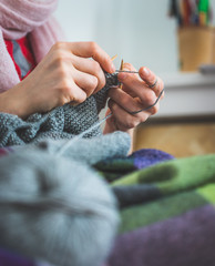 Knitting at home: Close up of wool, thread and female fingers