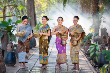 Asian beautiful woman splashing water in water festival Songkran at Thailand,Water Songkran festival.