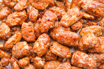 Nuts pile background. Sugar roasted pecan nuts (caramelized, praline nuts) in a glass on a white background, top view