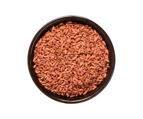 Uncooked red Dev-zira rice in a bowl isolated on a white background top view.