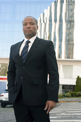 Black businessman in a suit loking successfull in an urban background