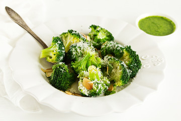 Broccoli cabbage with garlic and cheese with green sauce.