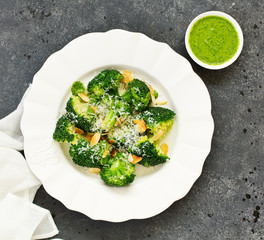 Broccoli cabbage with garlic and cheese with green sauce.