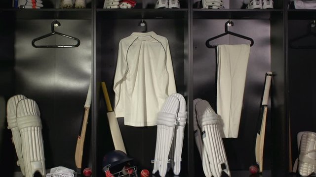 Cricket Changing room / Locker room. All the kit or uniform is laid out ready for the players. Tracking Shot Towards