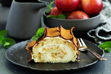 Roulade with apples and caramel, cream. New Year's dessert. Selective focus