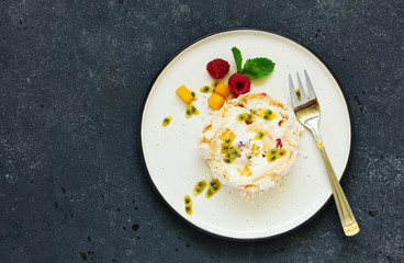 Meringue roulade with raspberries and passion fruit. Pavlova. Dessert. Selective focus