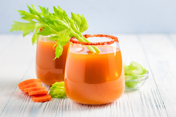 Vegan carrot celery juice in glasses. Copy space.