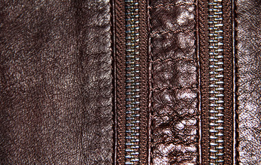 Two zippers on brown leather