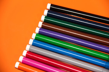 Fototapeta premium Markers in the right corner on an orange background.