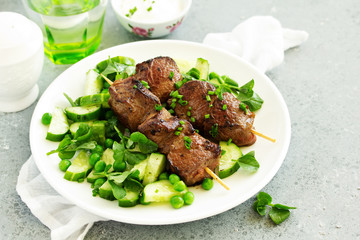 Beef kebab with cucumber and green pea salad. Healthy food.