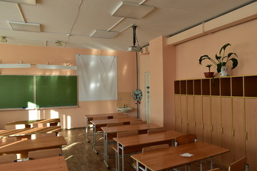 School classroom with desks and a projector