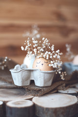 An egg with a painted smiling face and flowers.