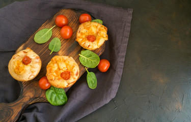 homemade cheese muffins on a dark background.