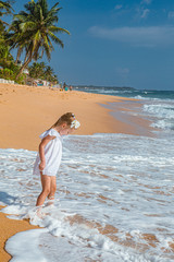 young woman walking on the beach