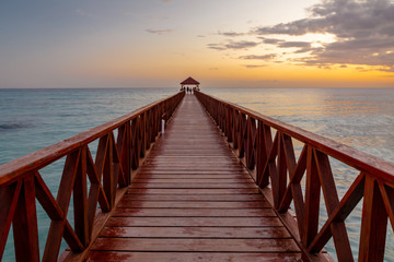 Fototapeta na wymiar Boat, Dominicus beach, sunset in the Dominican Republic, Caribbean sea at sunset.