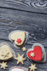 Marshmallow sandwiches decorated with cookies in the shape of a snowflake. On brushed pine boards painted in black and white.