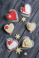 Marshmallow sandwiches decorated with cookies in the shape of a snowflake. On brushed pine boards painted in black and white.