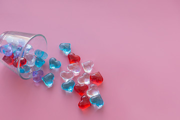 Crystal multicolored hearts on a pink background horizontal.