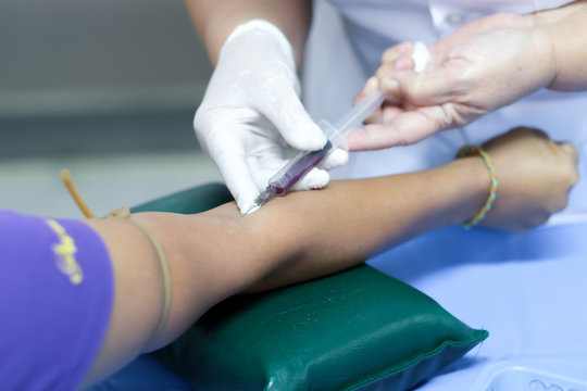 Doctor or nurse hands in medical blood collecting from a patient , Laboratory with nurse taking a blood sample from patient.