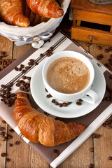 Composition with coffee cup and croissants