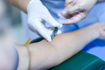 The process of a blood test for a woman's health check in the hospital to check blood sugar or glucose and cholesterol levels in the annual health examination program. Health care and medical