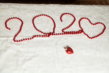Valentine's card of red beads on a white background