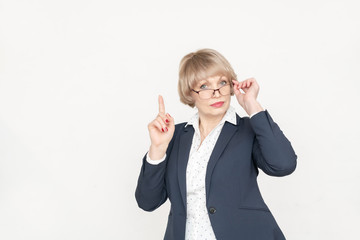 A beautiful 48 - year-old woman in business style-a light-colored shirt with black polka dots and a...