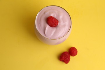 delicious raspberry yogurt in color background