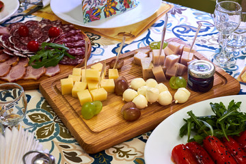 Three various cheeses and grapes on the board