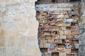       old ruined brick wall and stucco                        