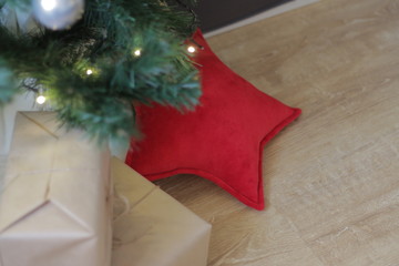 decorative star pillow as a gift under the Christmas tree