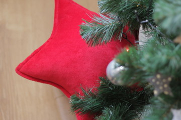 decorative star pillow as a gift under the Christmas tree