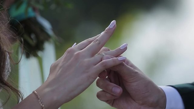 The groom puts the wedding ring on finger of the bride. marriage hands with rings. The bride and groom exchange wedding rings.
