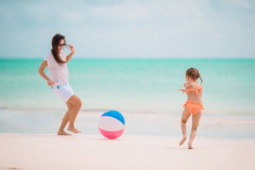 Beautiful mother and daughter at the beach enjoying summer vacation.