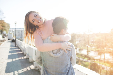 Fototapeta premium Lovely couple having fun. Young attractive woman and handsome man together walking in the city. Relationship.