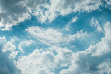 Evening sunset sky with bright rays of the sun and beautiful colorful clouds