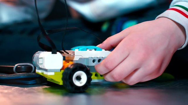 Close-up of childrehands assembling a constructor.