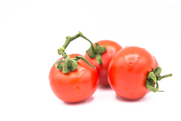 ripe fresh organic tomatoes in drops of water Isolated on a white background	