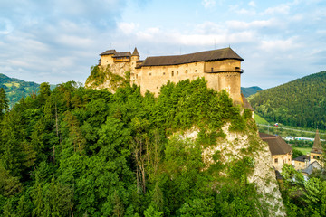 Fototapeta na wymiar Orava castle - Oravsky Hrad in Oravsky Podzamok in Slovakia. Medieval fortress on extremely high and steep cliff. Aerial view
