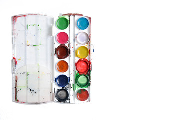 Aquarelle colors in a plastic box.  watercolor paint for kid, close-up isolated on white background. Painting art concept