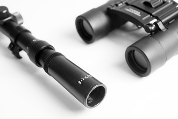 sniper optical scope for rifle and binoculars close-up on a white background. optical accessories concept