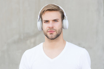 Foldable Stereo Headphones. Noise Reduction. Wireless Earpiece. Handsome guy wear headphones grey...