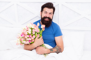 Spring mood. spring fresh tulip. love valentines day. womens day. tulip flower for march 8. good morning flowers. positive mood and happiness. happy bearded man in bed. birthday gift bouquet