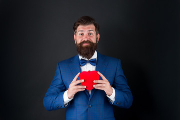 Romance and dating. Gentleman romantic soul. Man hold heart symbol of love. Dating services. Gentleman concept. True gentleman. Valentines day. Well groomed handsome bearded man wear tuxedo