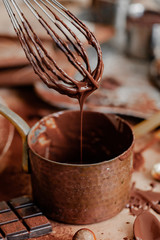 Process of preparation delicious homemade chocolate. Whisk mixer, vintage tableware, ingredients on teh table. Gourmet dessert . Close up, macro