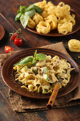 The concept of Italian cuisine. Pasta with zucchini and cheese on an old wooden background